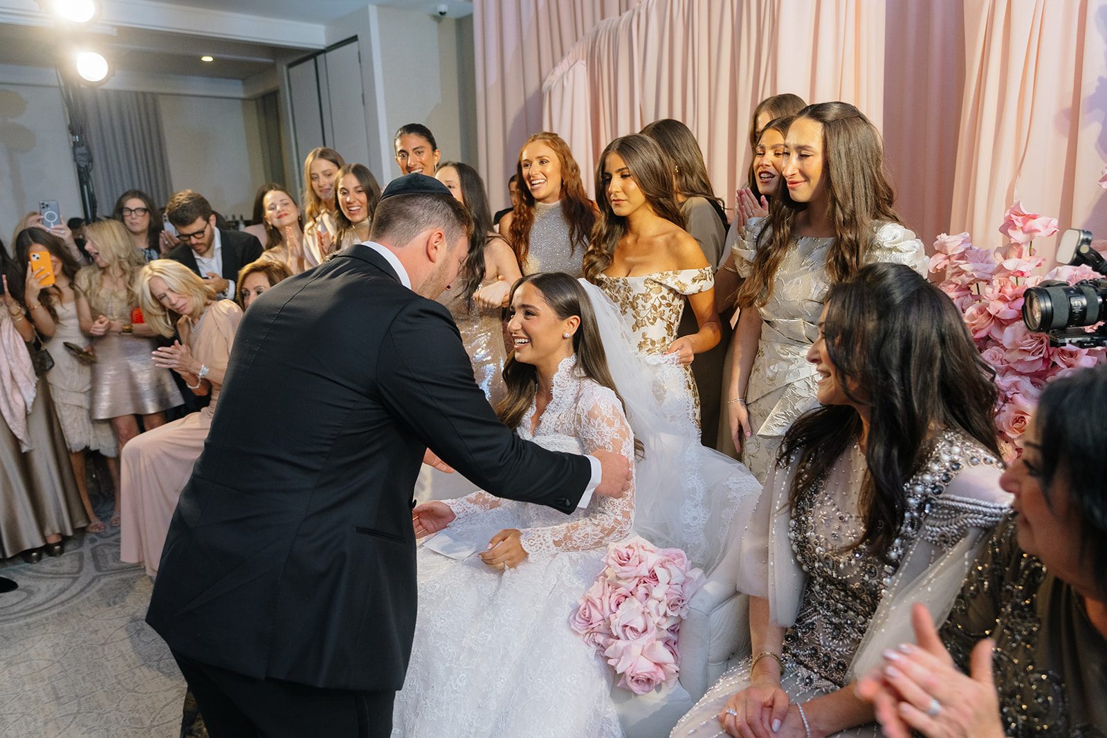 Josh approaching Rosalie at the badeken surrounded by bridesmaids