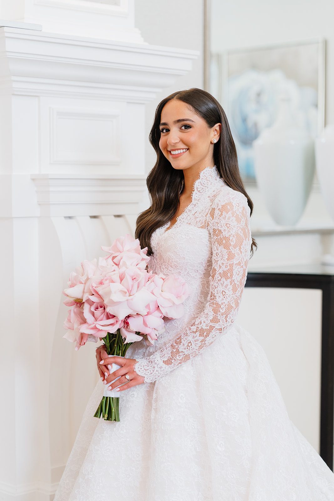 Rosalie holding a pink peony bouquet inside Edgewood Country Club