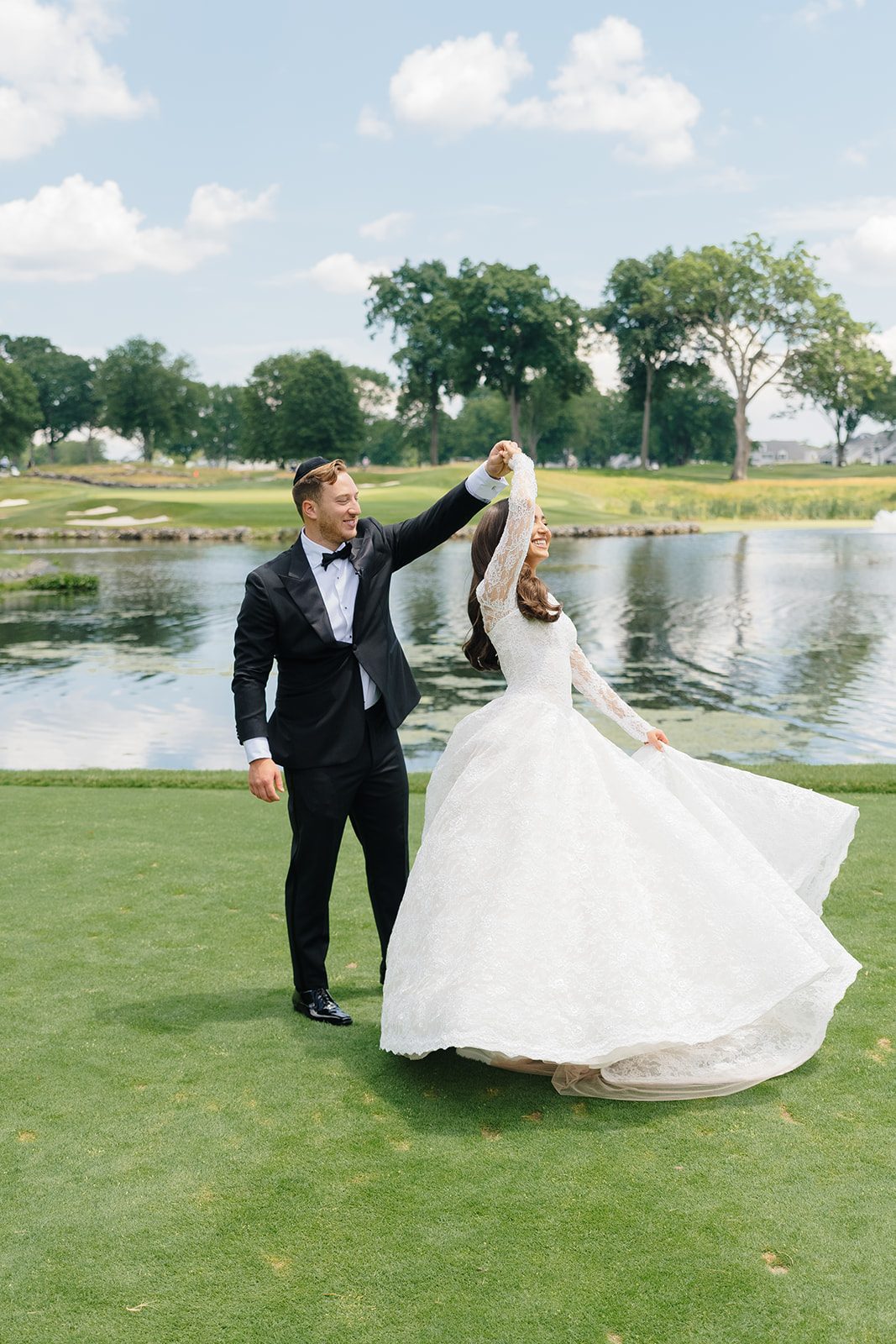 Josh twirling Rosalie in her ballgown beside the lake at Edgewood Country Club