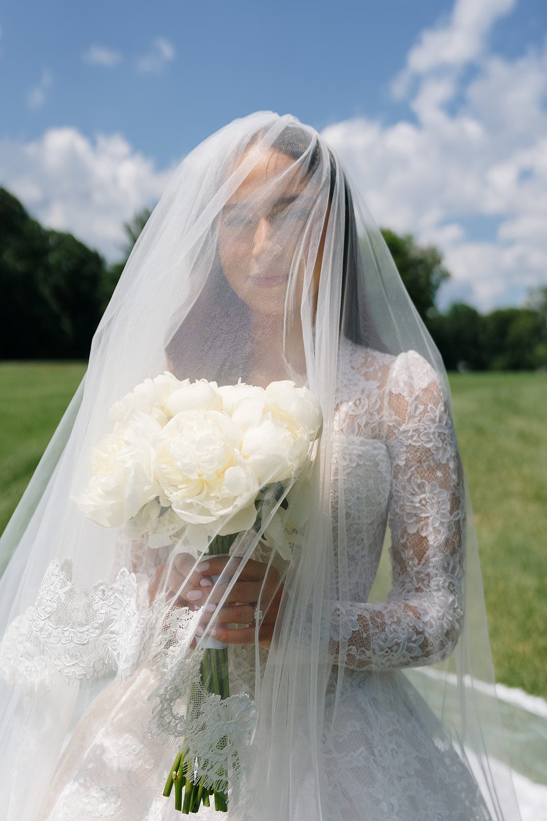 Bride beneath her cathedral veil holding white bouquet at Edgewood Country Club New Jersey