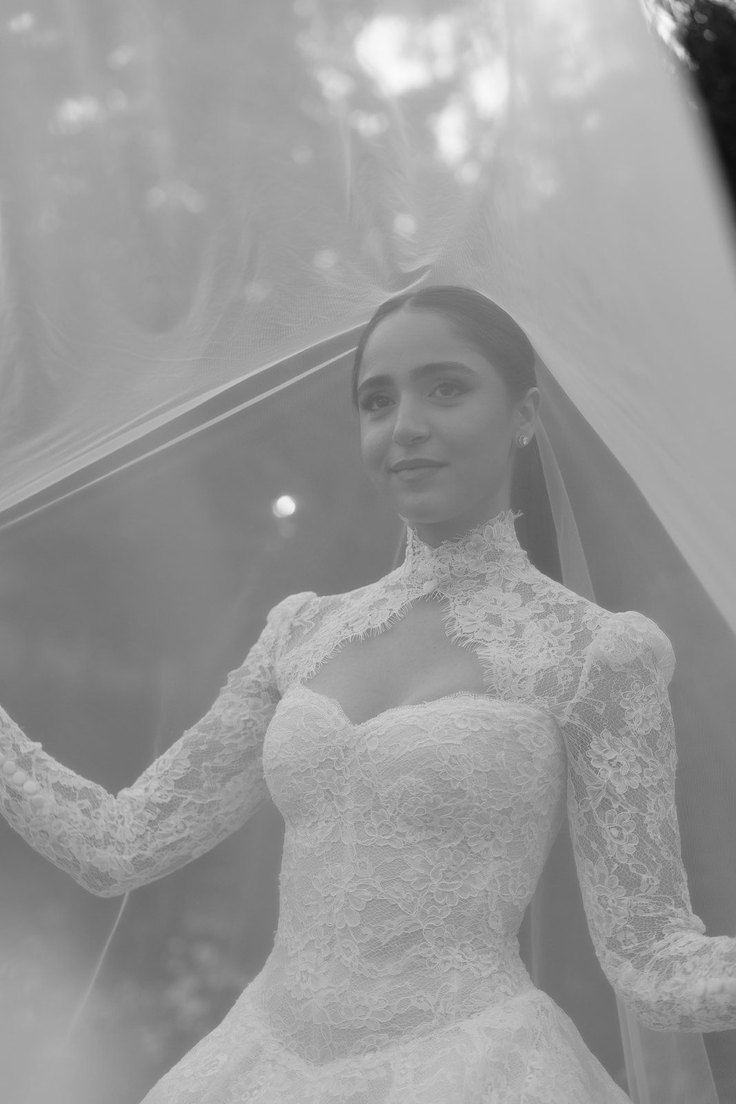 Soft black and white portrait of Rosalie through her veil