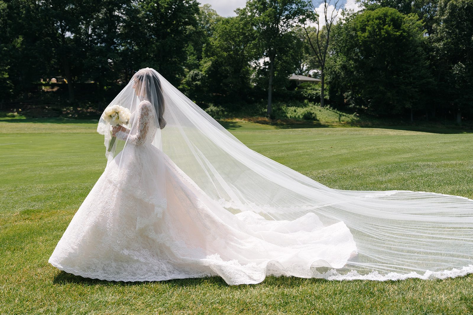 Cathedral veil and Anna Augusta gown train sweeping across the lawn at Edgewood Country Club
