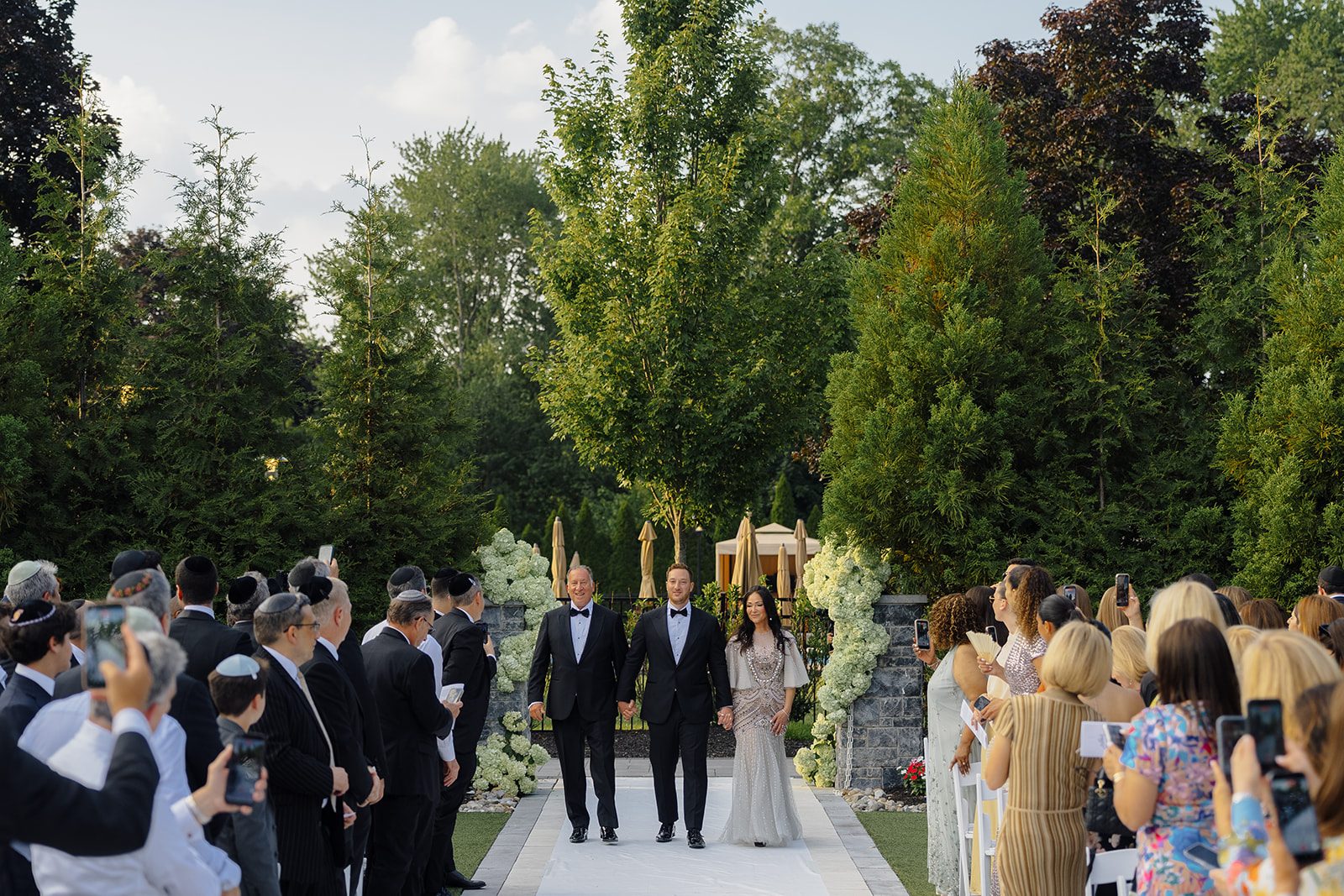 Groomsmen processional down the garden aisle at Edgewood Country Club