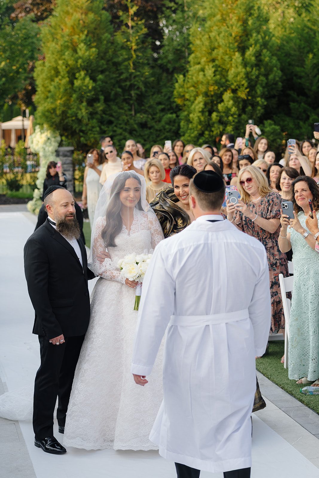 The ceremony under the white and green chuppah at Edgewood Country Club