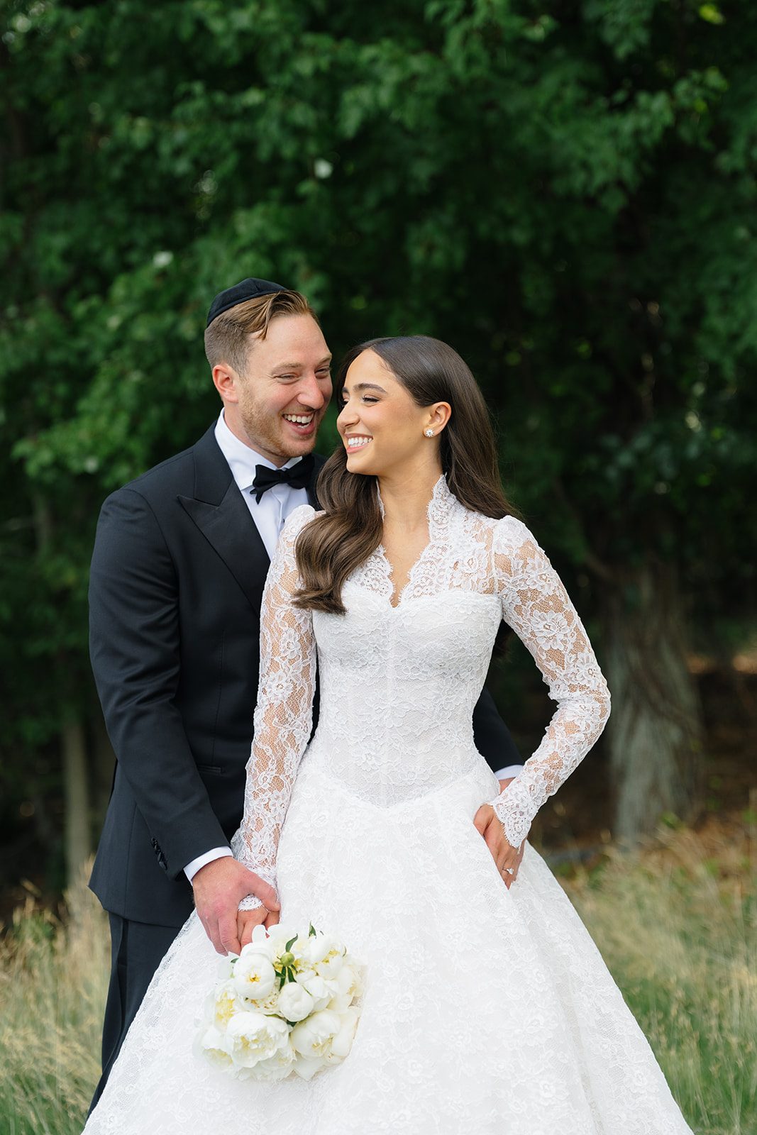 Rosalie and Josh laughing together on the lawn at Edgewood Country Club