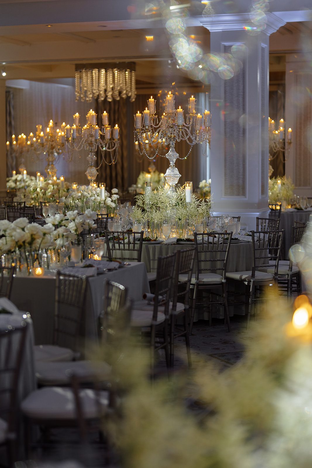 Candlelit ballroom reception tables with white florals at Edgewood Country Club