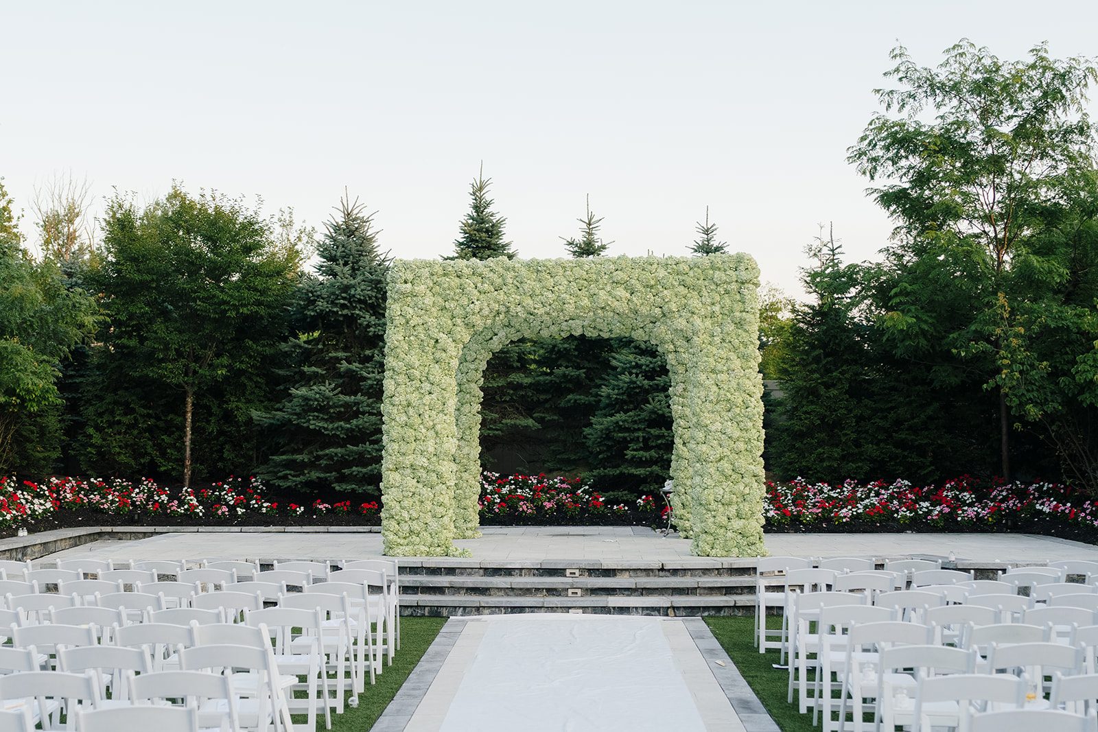 White and green floral chuppah on the ceremony lawn at Edgewood Country Club in River Vale New Jersey