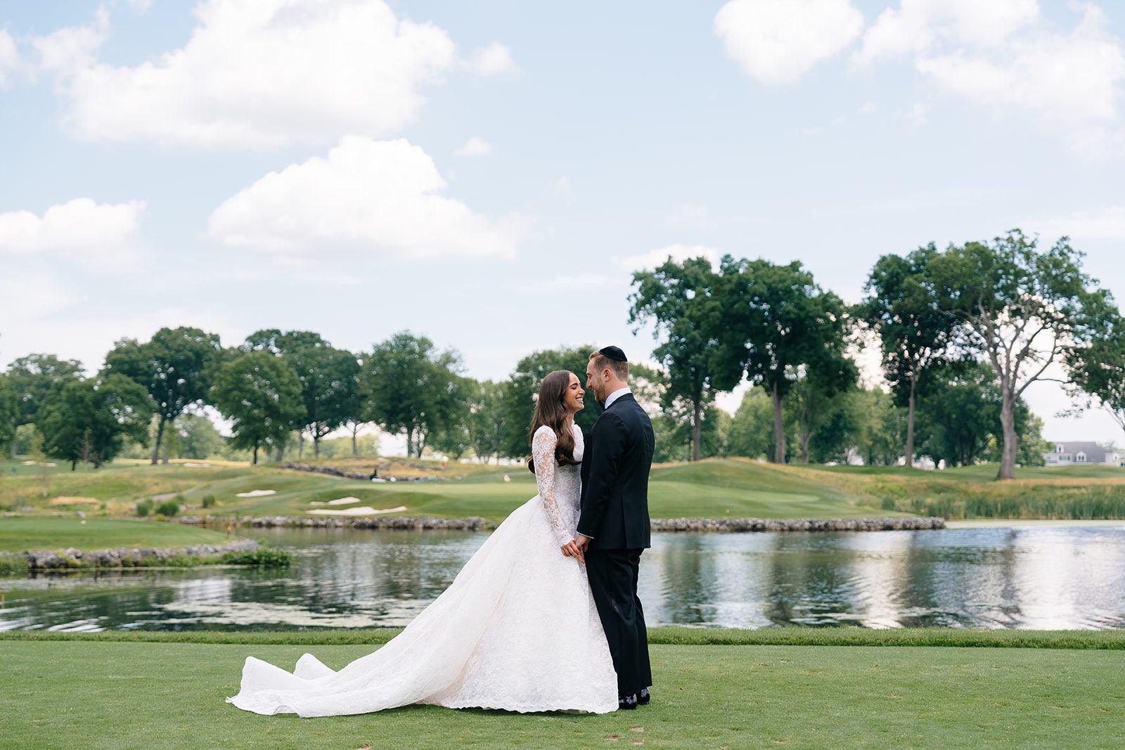 Wide portrait of the couple on the sweeping lawn at Edgewood Country Club River Vale NJ