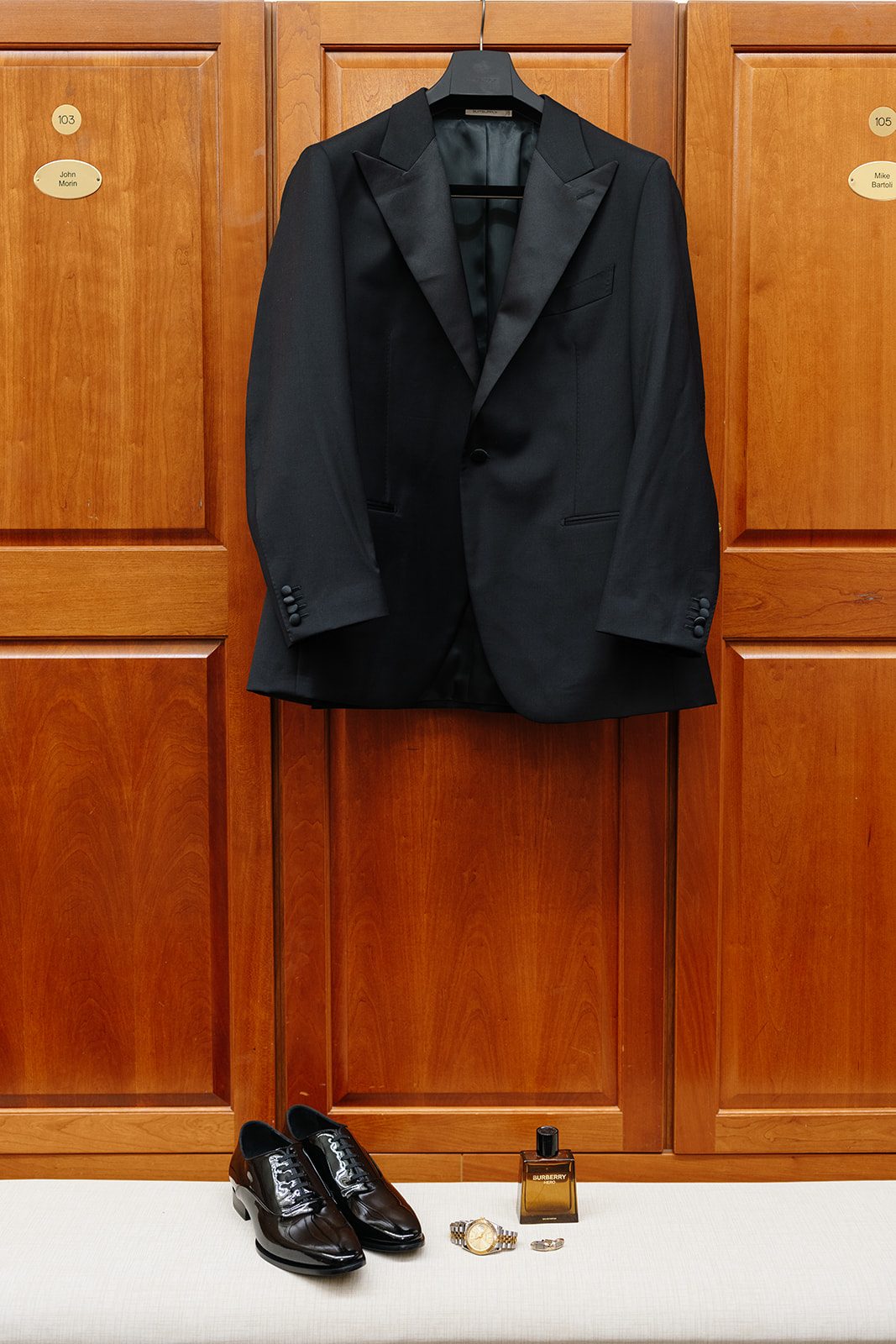 Groom&rsquo;s black tuxedo, shoes, and cologne detail before an Edgewood Country Club wedding
