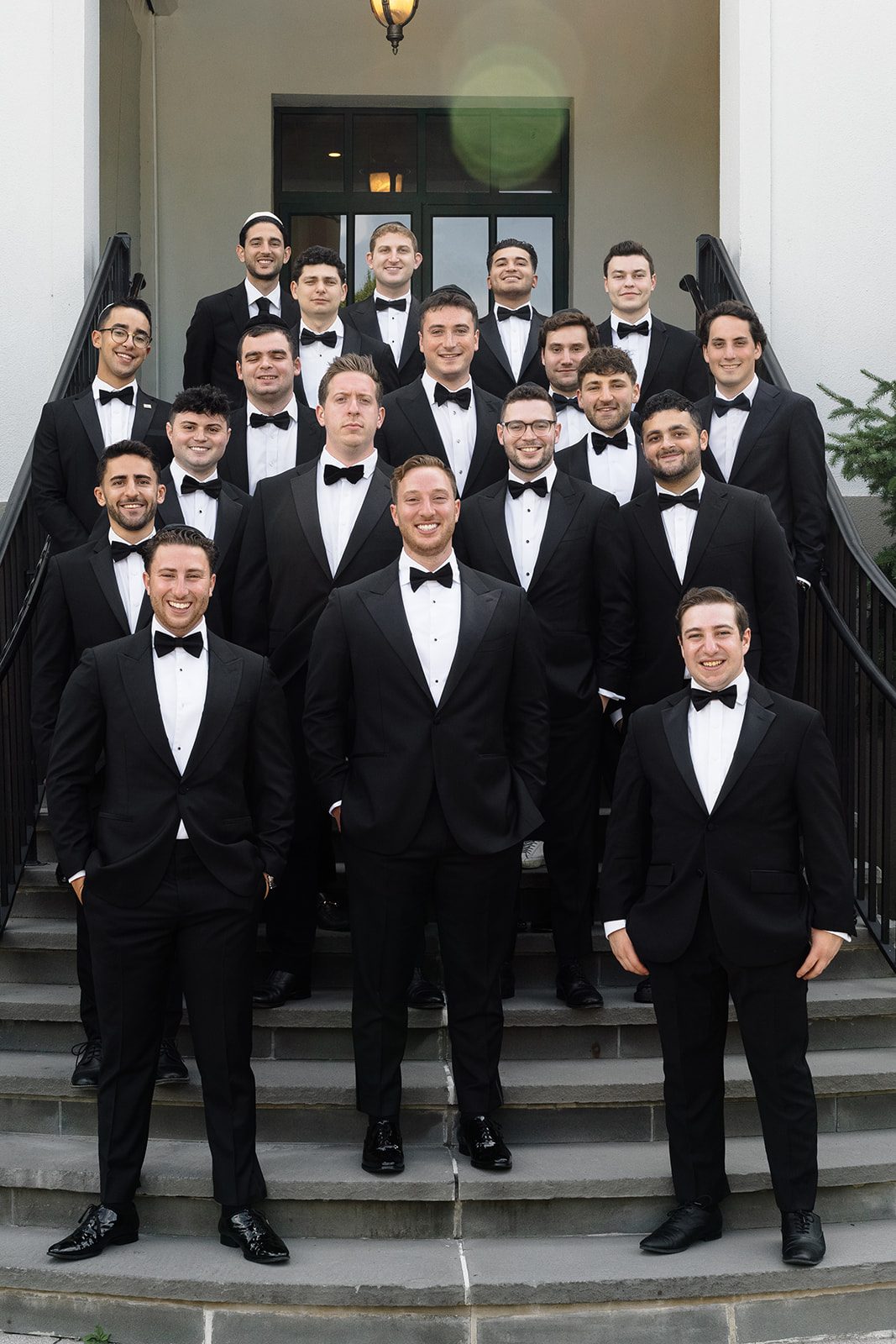 Josh and twenty groomsmen on the steps of Edgewood Country Club
