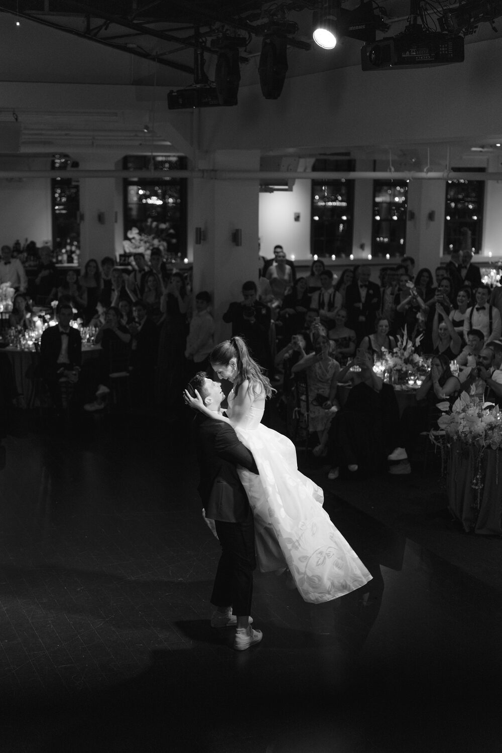 A black and white spin on the dance floor as guests watch from every side.