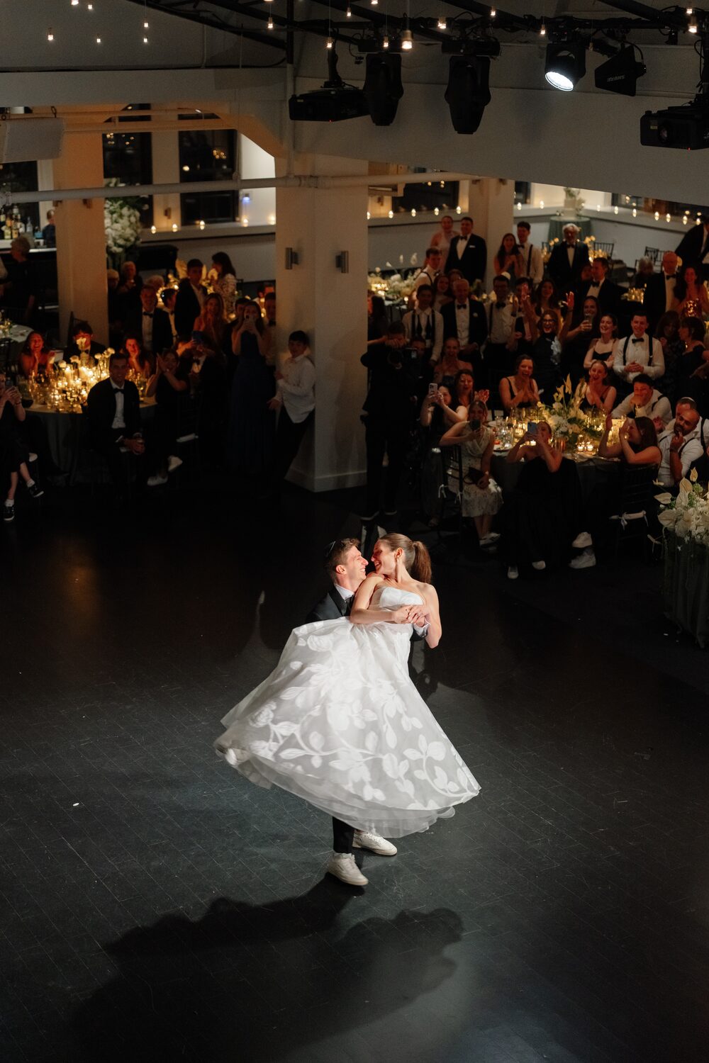 The bride's gown flares mid-twirl during the first dance.