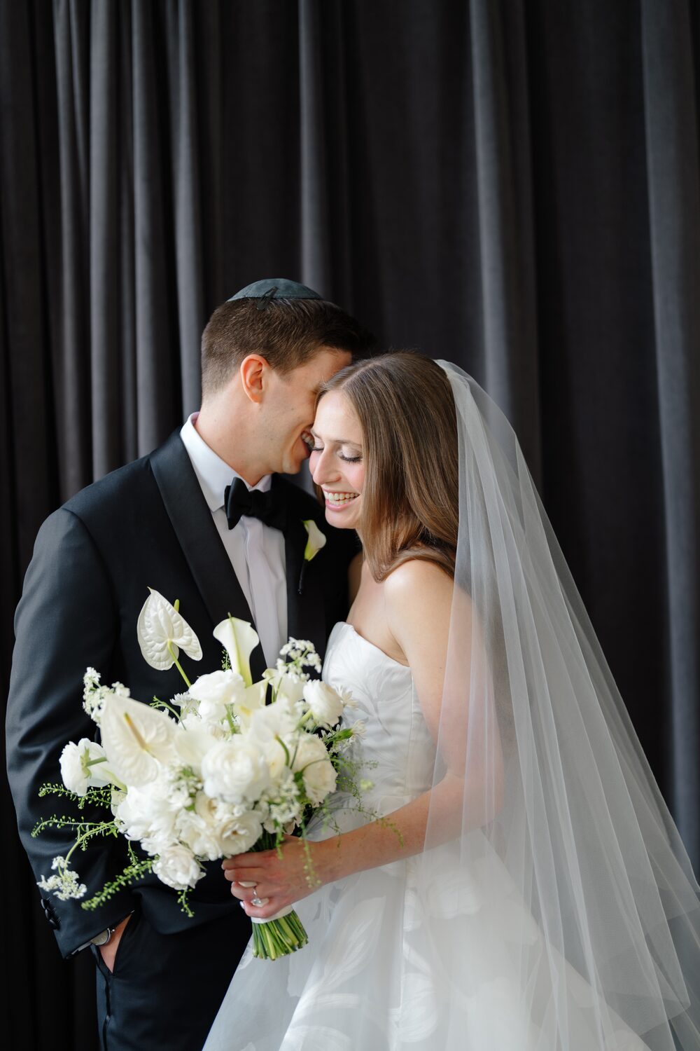 A quiet portrait after the ceremony, her calla bouquet held between them.