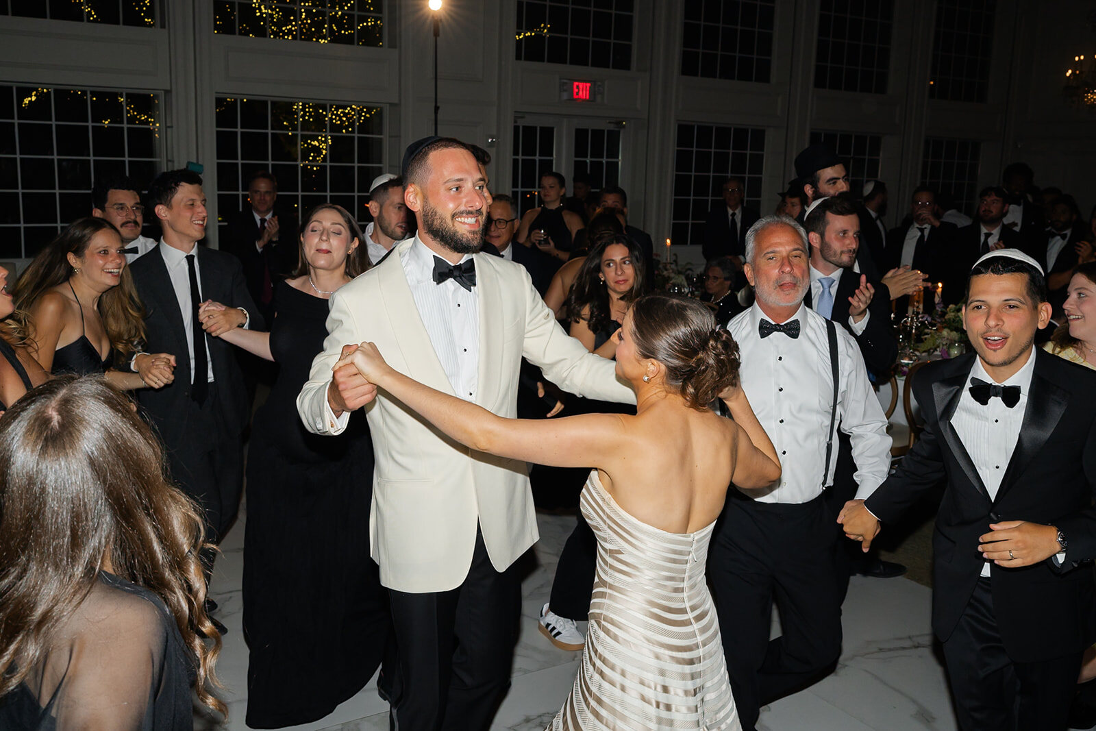 Joel leads Yarden into the hora as the ballroom fills with guests