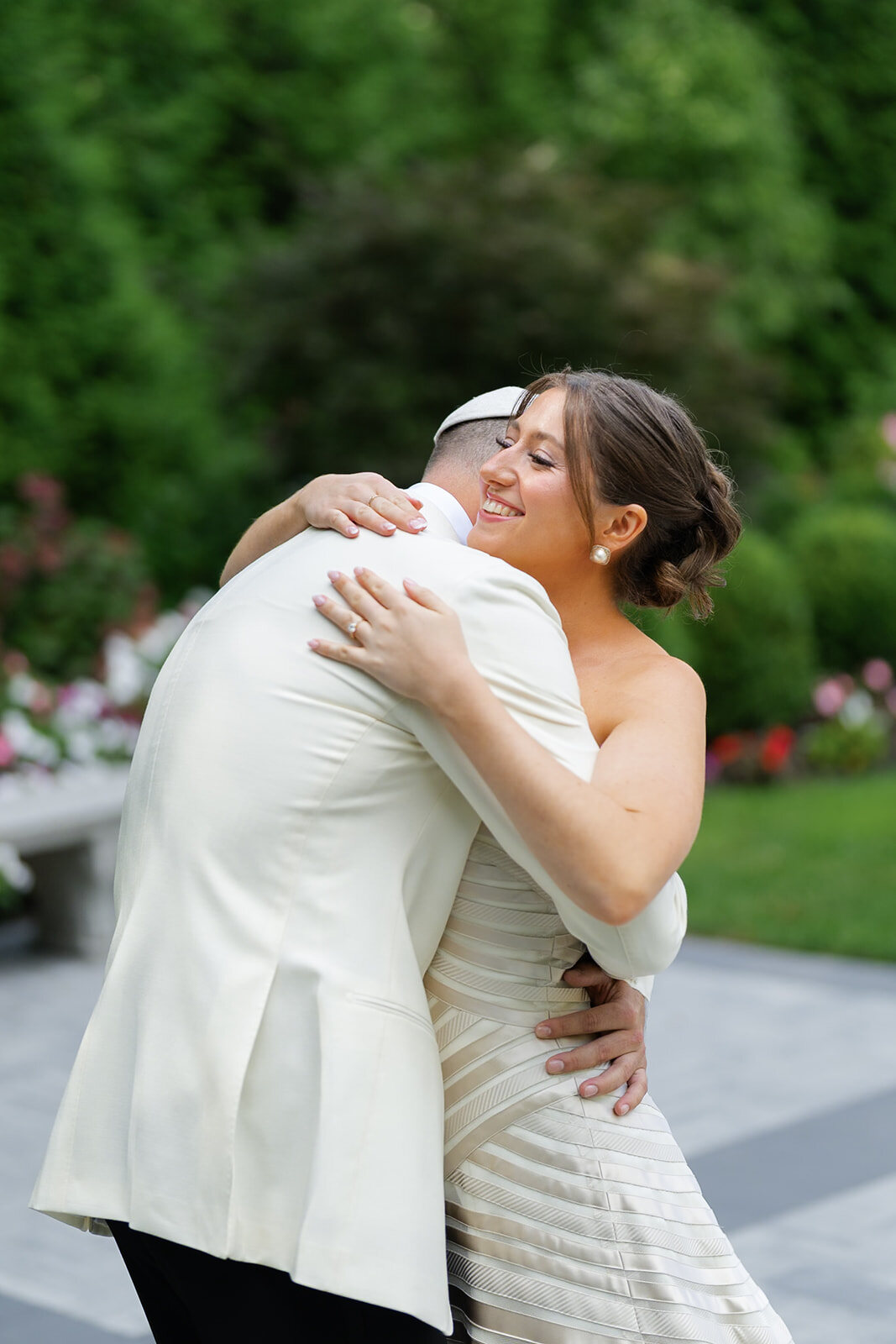 Yarden and Joel hold each other tightly in the gardens moments after their first look