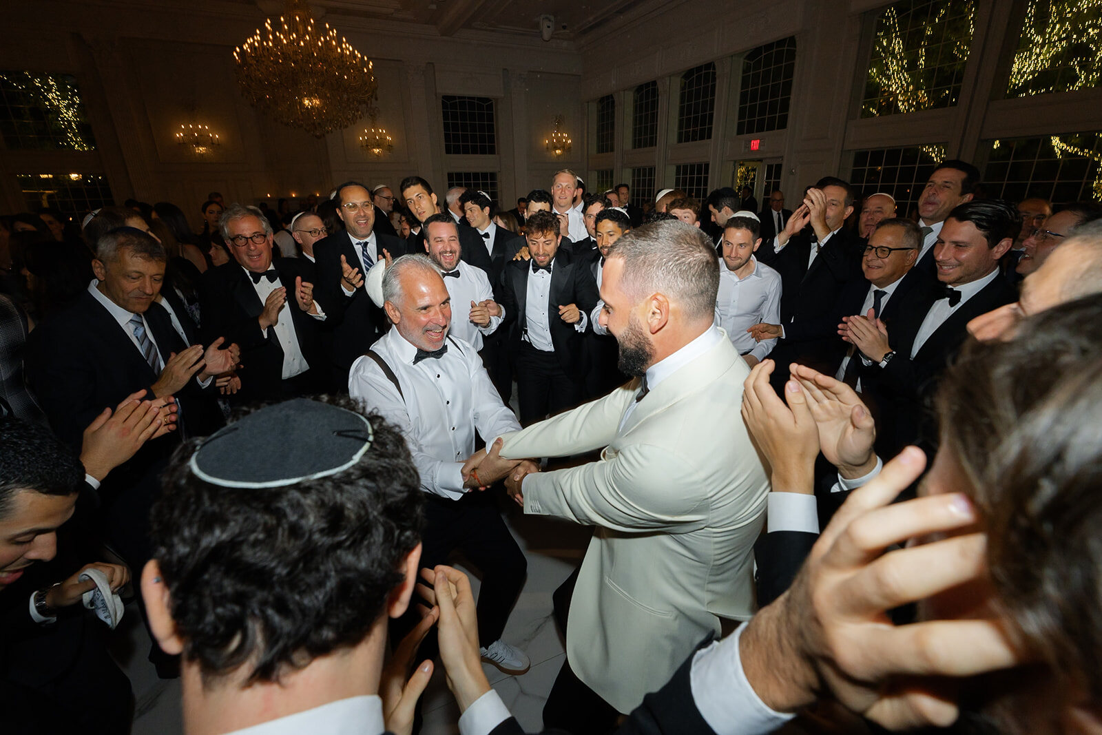 Joel dances with his friends in the middle of the hora
