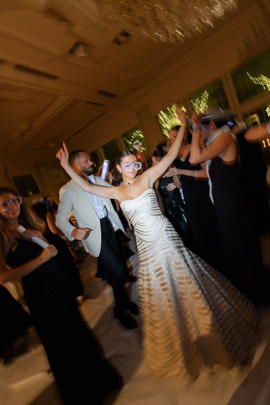 Yarden dances with her arms raised as her friends celebrate around her