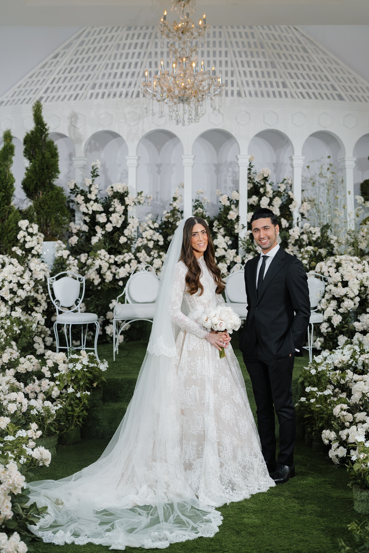 Bride and groom beneath the floral chuppah, original grade