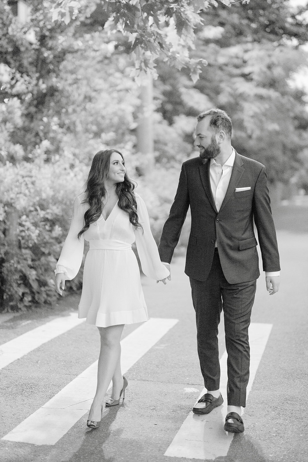 Couple walking hand in hand in casual outfits