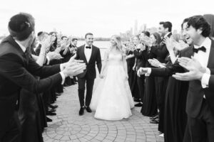 Bridal party applauds the couple's exit, black and white, Brooklyn wedding