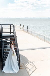 Bride descends the pier staircase on the Liberty Warehouse waterfront