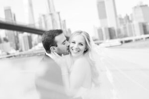 Black and white couple portrait with the Brooklyn Bridge and Manhattan skyline