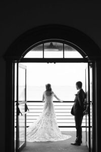 Couple silhouetted in a Liberty Warehouse doorway overlooking the harbor, black and white