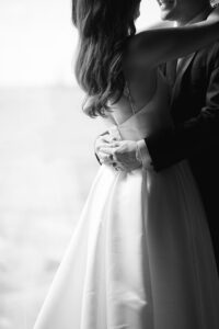 Black and white detail of the couple's embrace on their wedding day